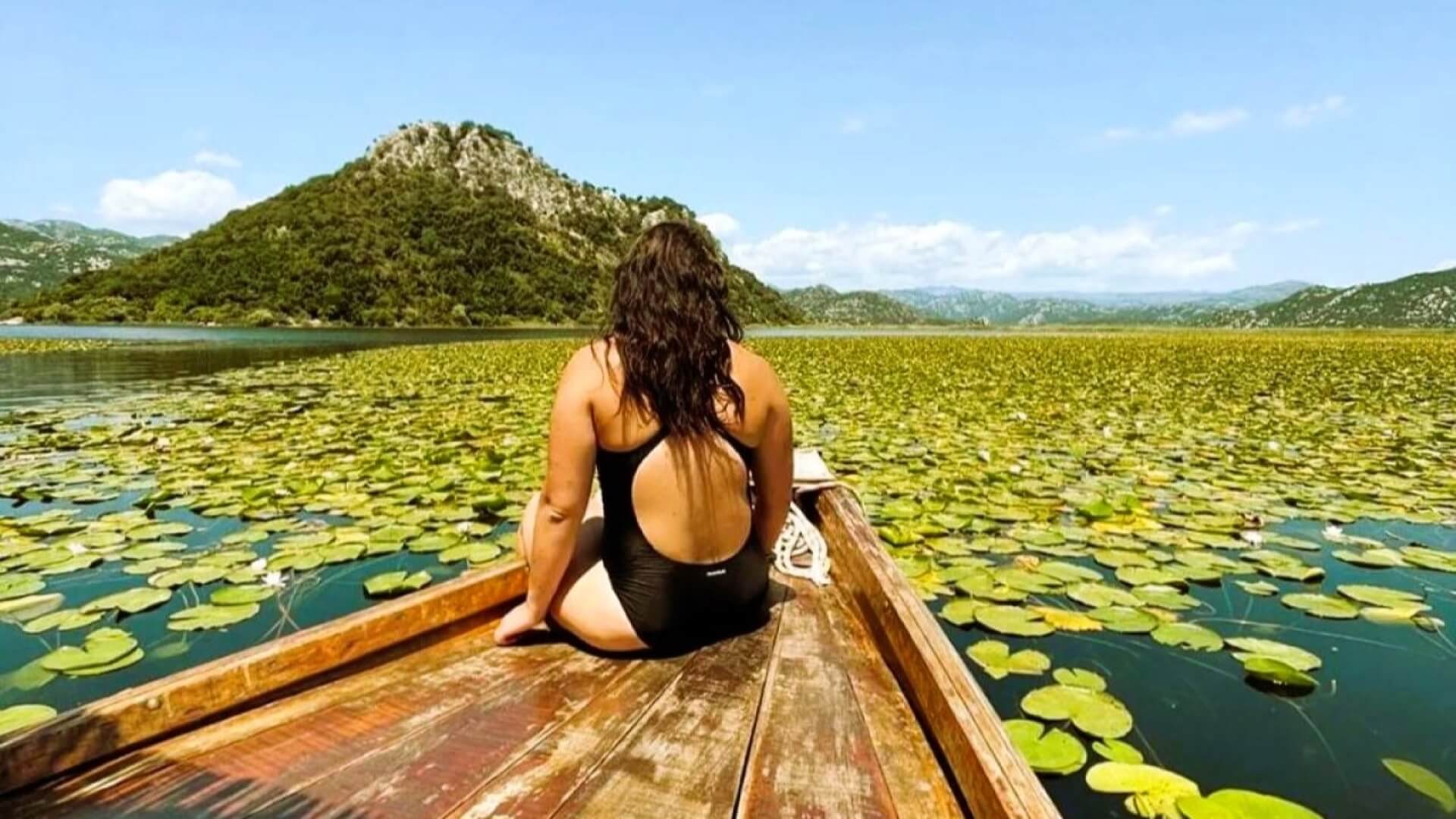 Enjoying the beauty of Skadar lake, tucked inside a traditional wooden boat
